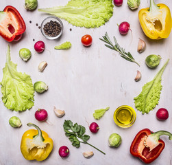 Delicious assortment of farm fresh vegetables lined frame on wooden rustic background top view close up place for text