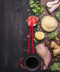 uncooked rice with cilantro, ginger, soy sauce, oyster mushrooms, and lemon, chicken breast, red chopsticks, concept of Japanese food on wooden rustic background top view close up border, place text
