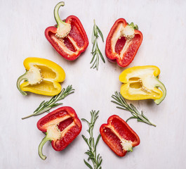 cut colorful fresh peppers with herbs on wooden rustic background top view close up