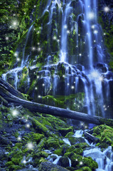 Waterfall with fairies and magical blue moonlight affect/Magical waterfall with fairies and blue misty water cascading over green mossy rocks © wishfaery14