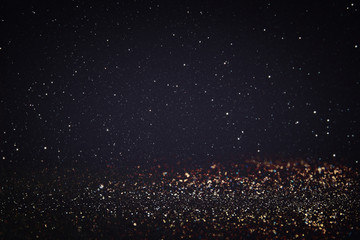 glitter vintage lights background. light silver, gold, black. defocused.
