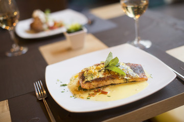 Grilled salmon with sauce and herbs