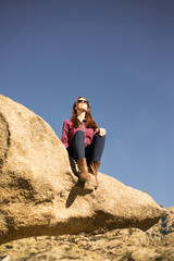 Woman sitting on a Rock