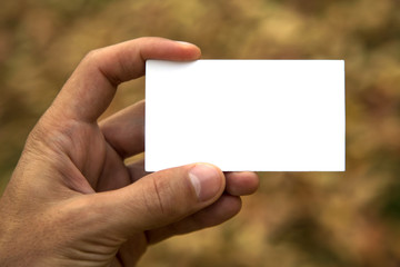 Holding blank card on abstract background