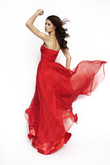 Brunette model in red dress posing
