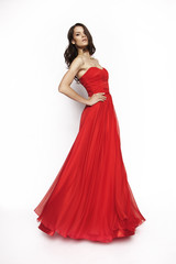 Brunette model in red dress posing
