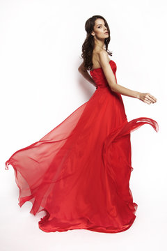 Brunette model in red dress posing
