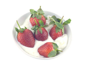 Strawberry with cream in round bowl isolated on white closeup