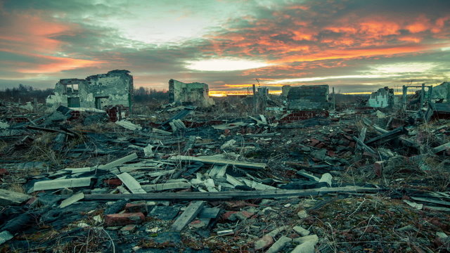Apocalyptic landscape.The remains of destroyed houses at sunset