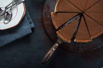 Sliced chocolate tort on dark background