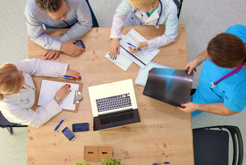 Male and female doctors working on reports in medical office