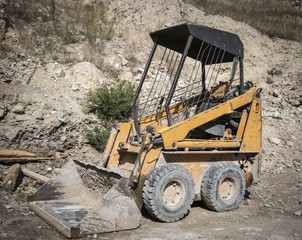 yellow excavator on a construction site