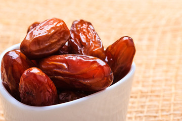 dried dates in bowl on table background
