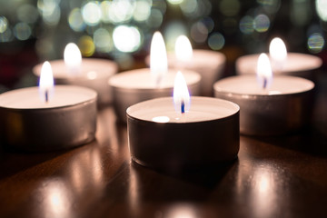 7 Romantic Tealights For Dinner On Wooden Table With Bokeh At Night