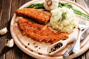 
meat with garnish , chicken cutlets in breadcrumbs , boiled mashed potatoes with herbs , garlic...