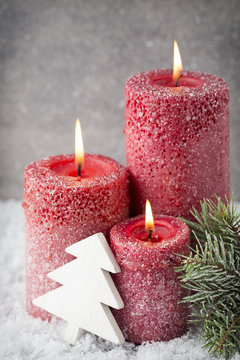 Three red candles on gray background, Christmas decoration. Adve