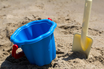 Children's beach toys - buckets and shovel on sand. Sunny day
