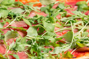 italian pizza with rocket salad 
