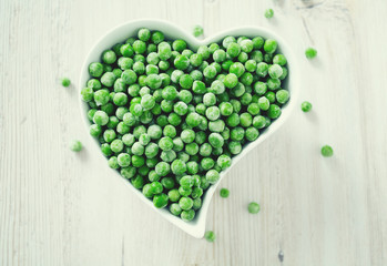 frozem peas on wooden surface