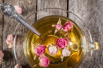Closeup of green tea cup with dried roses