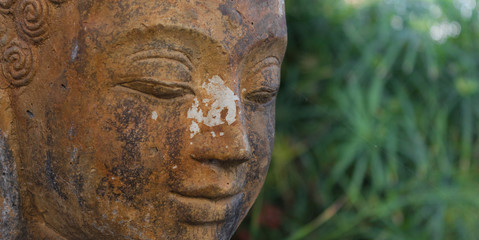 Fototapeta na wymiar buddhist statue in nature - garden decoration