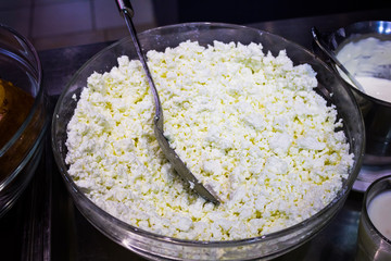 Cottage cheese in white bowl on old table