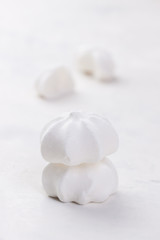 Closeup of meringue cookies on a white background, selective focus.