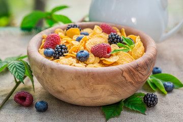 Sweet cornflakes with milk and berry fruits