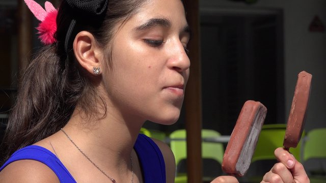 Teen Girl Eating Chocolate Ice Cream