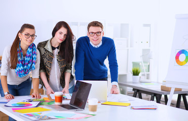 Young business people standing at office near desk