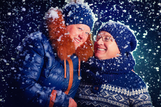 Happy Mature Couple Under The Snow