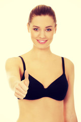 Obraz premium Woman in bikini with thumbs up.