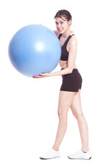 Young woman doing exercises with fitness ball.