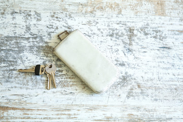 Keys and a smartphone on a wooden table
