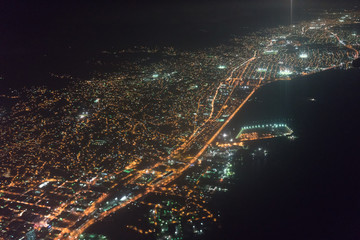 Aerial view of illuminated city seen through airplane at night, Trinidad, Trinidad And Tobago