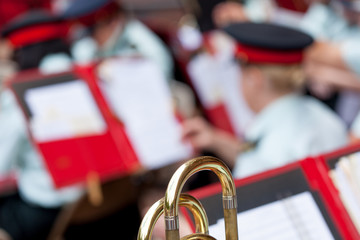 Close-up of Trombone with military band in the background