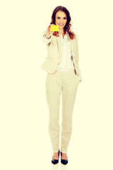 Businesswoman holding blank card.