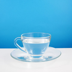 The glass cup of pure water on a white table.