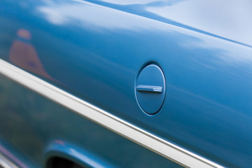 Obraz na płótnie Canvas Full frame shot of petrol tank of a blue shiny classic vintage car