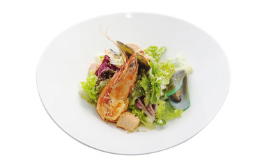 salad with seafood in a white plate isolated