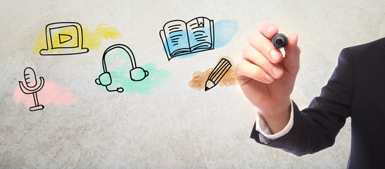 Businessman drawing E-Learning concept