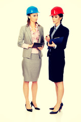 Two engineer woman discussing with eachother.