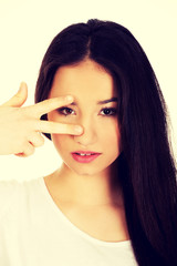 Young woman showing victory sign.