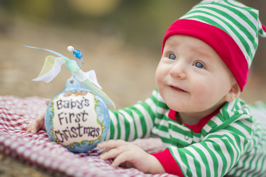 Infant Baby On Blanket With Babys First Christmas Ornament