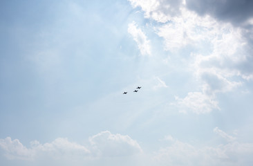 Low angle view of fighter airplanes performing airshow in sky