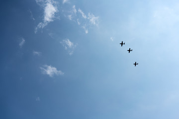 Low angle view of fighter airplanes performing airshow in sky