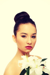 Fototapeta premium Beauty face of a woman with flower.