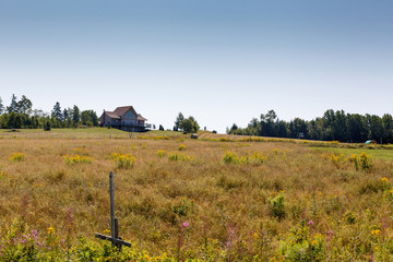 Scenics view of farmhouse in meadow against sky, Prince Edward Island, Canada