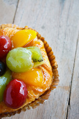 close up danish pastry with fruit on wood table