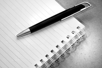 black pen on book, black and white picture
